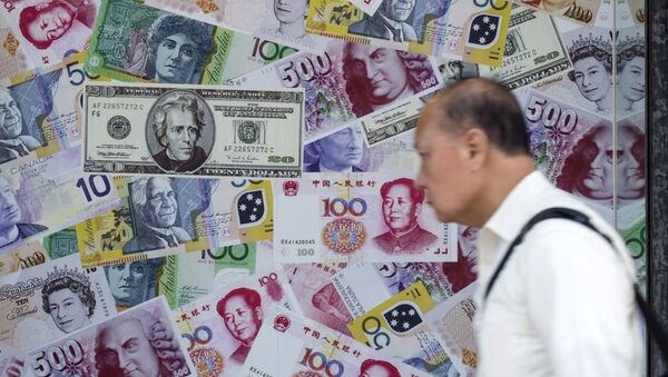 A man walks past an advertisement promoting China's renminbi (RMB) or yuan, U.S. dollar and Euro exchange services at foreign exchange store in Hong Kong, China, August 13, 2015 - Sputnik International