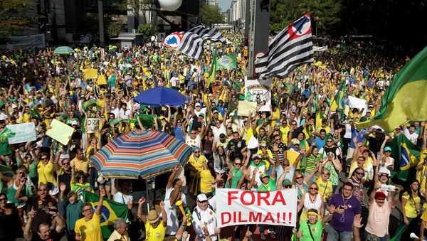 Demonstrators hold a sign that reads in Portuguese Dilma out during a protest demanding the impeachment of Brazil's President Dilma Rousseff in Sao Paulo, Brazil - Sputnik International