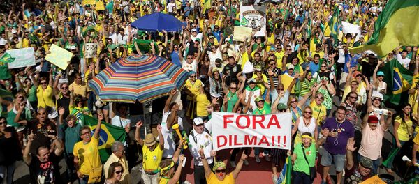 Demonstrators hold a sign that reads in Portuguese Dilma out during a protest demanding the impeachment of Brazil's President Dilma Rousseff in Sao Paulo, Brazil - Sputnik International
