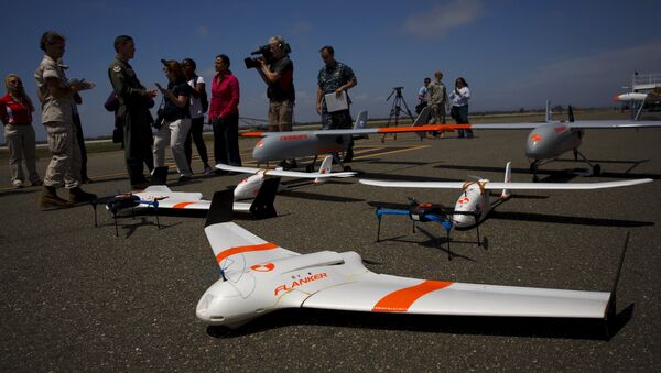 FireFlight UAS unmanned aerial vehicles TwinHawk, Scout, Flanker, and Hawkeye 400, are displayed on the tarmac during Black Dart, a live-fly, live fire demonstration of 55 unmanned aerial vehicles, or drones, at Naval Base Ventura County Sea Range, Point Mugu, near Oxnard, California July 31, 2015 - Sputnik International