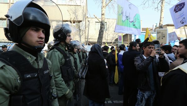Iranian security forces stand guard outside the French embassy in Tehran as demonstrators protest on January 20, 2015 - Sputnik International