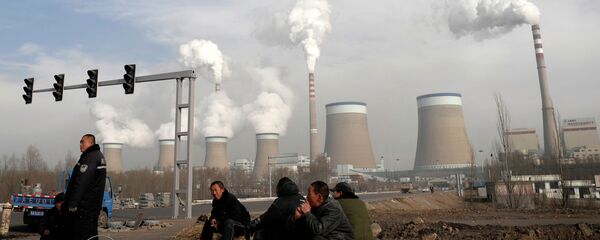 Chinese workers take a break in front of the cooling towers of a coal-fired power plant in Dadong, Shanxi province, China Chinese workers take a break in front of the cooling towers of a coal-fired power plant in Dadong, Shanxi province, China - Sputnik International