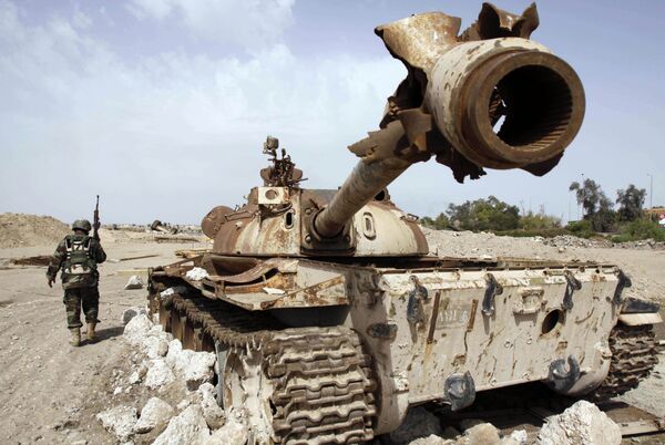 An Iraqi soldier is seen near an Iraqi Army tank, which was destroyed in the US-led invasion, in Basra, Iraq's second-largest city, 550 kilometers (340 miles) southeast of Baghdad, Iraq, Thursday, April 9, 2009 An Iraqi soldier is seen near an Iraqi Army tank, which was destroyed in the US-led invasion, in Basra, Iraq's second-largest city, 550 kilometers (340 miles) southeast of Baghdad, Iraq, Thursday, April 9, 2009 - Sputnik International