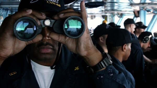 US Navy sailor CW02 Ernest Jackson, 42, of San Diego, California, peers through binoculars from the bridge of the USS Nimitz on Tuesday, June 5, 2007, in the Persian Gulf, where the Nimitz and the USS John C. Stennis aircraft carrier groups are on patrol - Sputnik International
