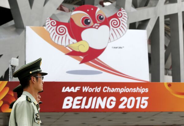 Paramilitary policemen listen to instructions in front of the logo of the upcoming 15th IAAF World Championships at the Beijing National Stadium. Paramilitary policemen listen to instructions in front of the logo of the upcoming 15th IAAF World Championships at the Beijing National Stadium. - Sputnik International
