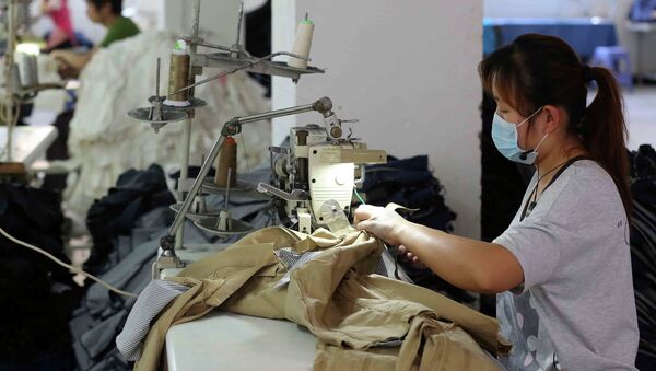 This picture taken on May 12, 2015 shows Chinese workers making jeans at a clothing factory in Shishi, east China's Fujian province. - Sputnik International