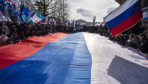 Participants of a rally celebrating the Crimean Spring's first anniversary in front of the Crimean State Council in Simferopol. - Sputnik International