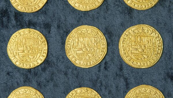 Over 350 gold coins from a sunken Spanish Treasure are seen in an undated handout picture courtesy of 1715 Fleet - Queens Jewels - Sputnik International