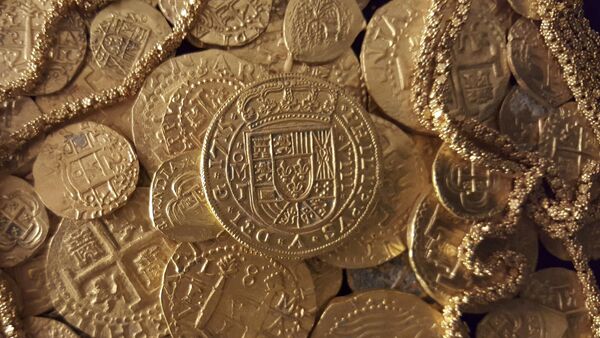 Gold coins and gold chain found in the wreckage of a 1715 Spanish fleet that sunk in the Atlantic off the Florida coast are seen in an undated handout picture courtesy of 1715 Fleet - Queens Jewels LLC - Sputnik International