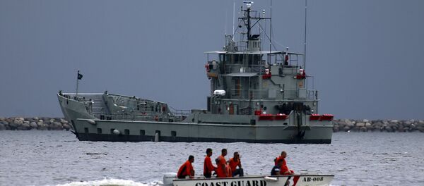Members of the Philippine coast guard on a motorboat drive past one of the two decommissioned Landing Craft Heavy (LCH) vessels donated by the Australian government to the Philippines, docked at a bay in Manila August 9, 2015 Members of the Philippine coast guard on a motorboat drive past one of the two decommissioned Landing Craft Heavy (LCH) vessels donated by the Australian government to the Philippines, docked at a bay in Manila August 9, 2015 - Sputnik International