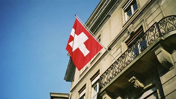 Swiss flag fluttering in the sunshine in Geneva - Sputnik International