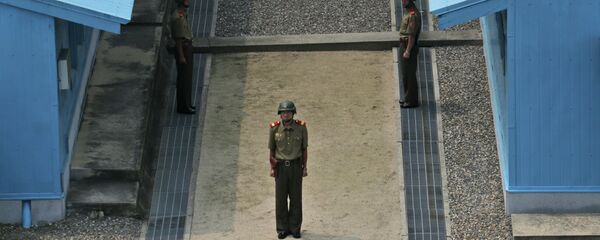 North Korean soldiers stand guard prior to a reunification rally in the border village of Panmunjom at the DMZ in North Korea, Saturday, Aug. 15, 2015. - Sputnik International