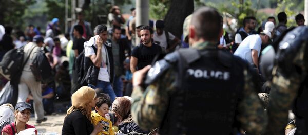Macedonian special policemen guard the border as more than a thousand immigrants wait at the border line of Macedonia and Greece to enter Macedonia near the Gevgelija railway station August 21, 2015 Macedonian special policemen guard the border as more than a thousand immigrants wait at the border line of Macedonia and Greece to enter Macedonia near the Gevgelija railway station August 21, 2015 - Sputnik International