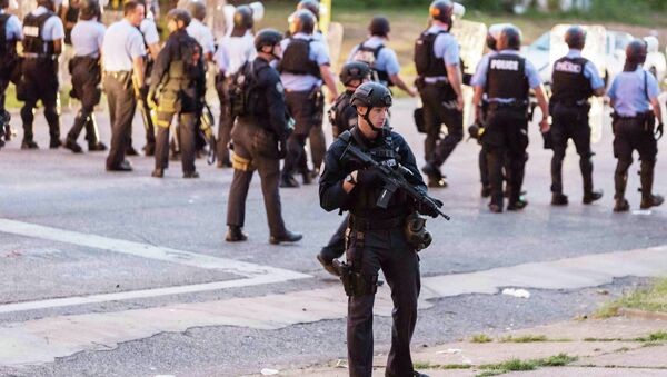 Police line up to block the street as protesters gathered after a shooting incident in St. Louis, Missouri August 19, 2015 - Sputnik International