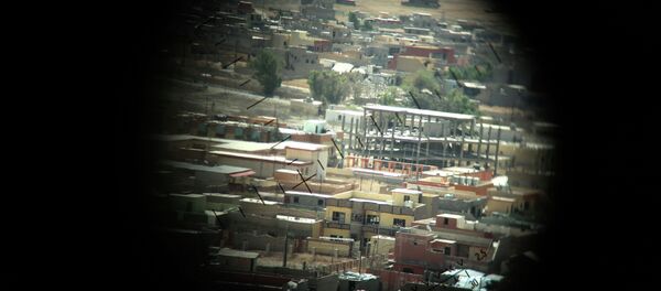 A picture taken through a machine gun sight on August 17, 2015 shows buildings that were damaged during fighting between Iraqi Kurdish Peshmerga fighters and the Islamic State (IS) group's militants in the northern Iraqi town of Sinjar, west of the city of Mosul. A picture taken through a machine gun sight on August 17, 2015 shows buildings that were damaged during fighting between Iraqi Kurdish Peshmerga fighters and the Islamic State (IS) group's militants in the northern Iraqi town of Sinjar, west of the city of Mosul. - Sputnik International