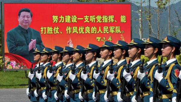 Chinese female troops practice marching near a billboard showing Chinese President Xi Jinping and the slogan Strive to build a People's Liberation Army that obeys the Party, Wins the war and has outstanding work style“ at a camp on the outskirts of Beijing, Saturday, Aug. 22, 2015 - Sputnik International