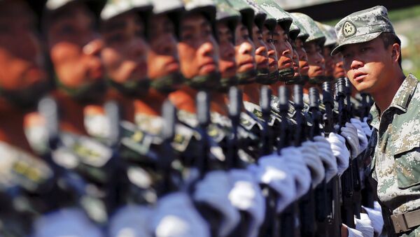 An officer gives instructions as soldiers of China's People's Liberation Army form a line during a training session for a military parade to mark the 70th anniversary of the end of World War Two, at a military base in Beijing, China, August 22, 2015 - Sputnik International