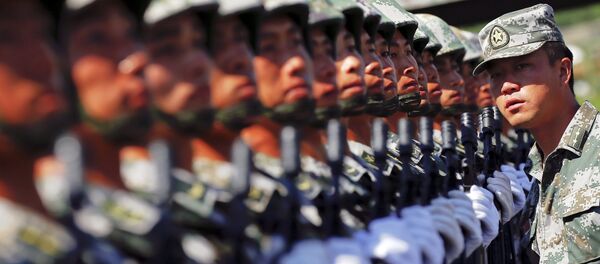 An officer gives instructions as soldiers of China's People's Liberation Army form a line during a training session for a military parade to mark the 70th anniversary of the end of World War Two, at a military base in Beijing, China, August 22, 2015 An officer gives instructions as soldiers of China's People's Liberation Army form a line during a training session for a military parade to mark the 70th anniversary of the end of World War Two, at a military base in Beijing, China, August 22, 2015 - Sputnik International
