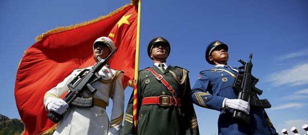 Officers and soldiers of China's People's Liberation Army hold a flag and weapons during a training session for a military parade to mark the 70th anniversary of the end of World War Two, at a military base in Beijing, China, August 22, 2015 Officers and soldiers of China's People's Liberation Army hold a flag and weapons during a training session for a military parade to mark the 70th anniversary of the end of World War Two, at a military base in Beijing, China, August 22, 2015 - Sputnik International