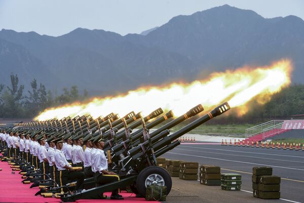 Paramilitary policemen and members of a gun salute team fire cannons during a training session for a military parade to mark the 70th anniversary of the end of the World War Two, at a military base in Beijing, China Paramilitary policemen and members of a gun salute team fire cannons during a training session for a military parade to mark the 70th anniversary of the end of the World War Two, at a military base in Beijing, China - Sputnik International