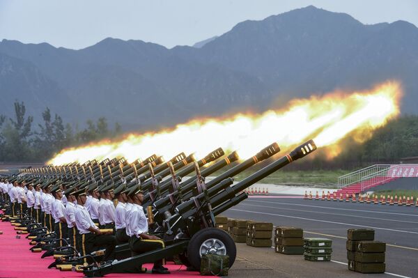 Paramilitary policemen and members of a gun salute team fire cannons during a training session for a military parade to mark the 70th anniversary of the end of the World War Two, at a military base in Beijing, China - Sputnik International