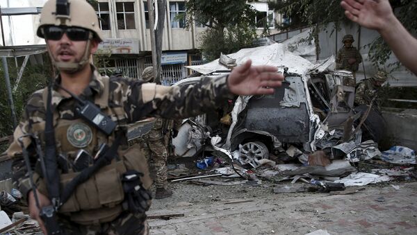 Members of Afghan security forces keep watch in front of a damaged car that belongs to foreigners after a bomb blast in Kabul, Afghanistan August 22, 2015. - Sputnik International