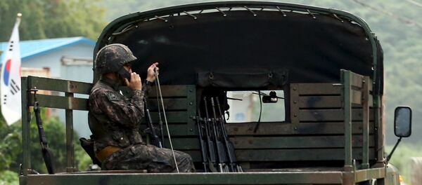 A South Korean soldier talks on a radio as he sits on a military vehicle at the demilitarized zone separating the two Koreas in Yeoncheon, South Korea - Sputnik International