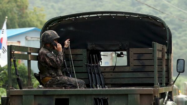 A South Korean soldier talks on a radio as he sits on a military vehicle at the demilitarized zone separating the two Koreas in Yeoncheon, South Korea - Sputnik International