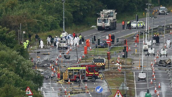 A crane arrives on site as emergency services and crash investigation officers continue to work at the site where a Hawker Hunter fighter jet crashed onto the A27 road at Shoreham near Brighton, Britain - Sputnik International