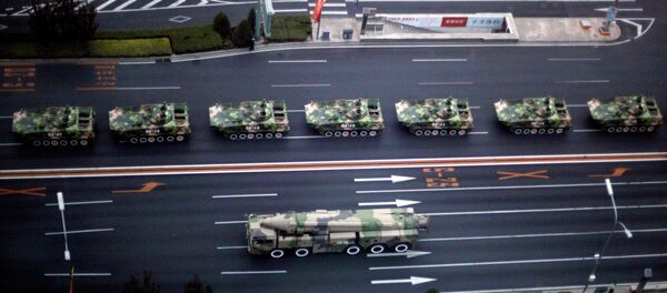 Military vehicle carrying a DF-21D carrier-killer missile, bottom, and other Chinese military vehicles head towards Tiananmen Square - Sputnik International