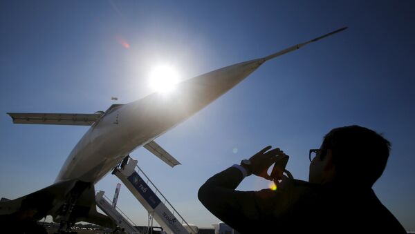 A visitor takes a picture of a Tupolev Tu-144 commercial supersonic transport aircraft on display at the MAKS International Aviation and Space Salon in Zhukovsky, outside Moscow, Russia, August 25, 2015 - Sputnik International