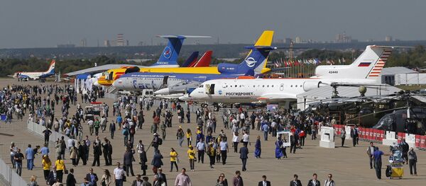 Visitors walk along a row of planes and helicopters on display at the MAKS International Aviation and Space Salon in Zhukovsky, outside Moscow, Russia, August 25, 2015 Visitors walk along a row of planes and helicopters on display at the MAKS International Aviation and Space Salon in Zhukovsky, outside Moscow, Russia, August 25, 2015 - Sputnik International