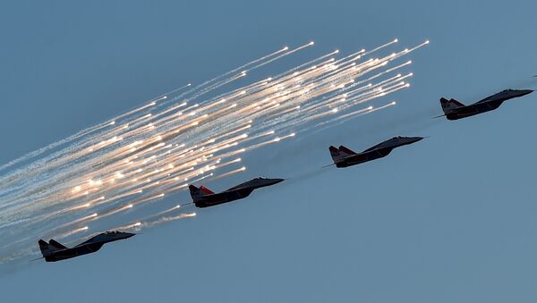 Russian aerobatic group Strizhi (Swifts) performs on MIG-29 jet fighters during the MAKS-2015, the International Aviation and Space Show, in Zhukovsky, outside Moscow, on August 25, 2015 - Sputnik International