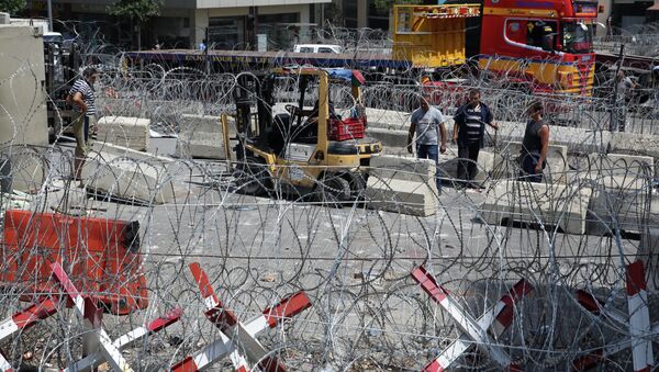 A Lebanese engineering unit install barriers after they remove a concrete wall that was installed by authorities, near the main Lebanese government building, in downtown Beirut, Lebanon, Wednesday, Aug. 26, 2015 - Sputnik International
