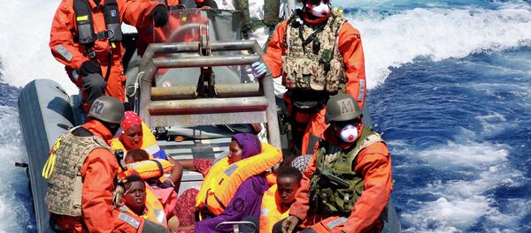 In this Aug. 23, 2015 picture provided by the German Navy pregnant Somali refugee, Rahma Abukar Ali center, sits in a boat of the German Navy in the Mediterranean Sea, near Italy In this Aug. 23, 2015 picture provided by the German Navy pregnant Somali refugee, Rahma Abukar Ali center, sits in a boat of the German Navy in the Mediterranean Sea, near Italy - Sputnik International