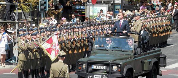 Polish President Andrzej Duda and Chief of Staff Gen. Mieczyslaw Gocul review troops prior to a military parade during Armed Forces Day in Warsaw, Poland August 15, 2015 - Sputnik International