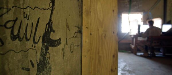Taliban graffiti shows an AK-47 assault rifle and the word 'Allah' at left, translated from Pashto, decorating a wall in the Musa Qala district center. Taliban graffiti shows an AK-47 assault rifle and the word 'Allah' at left, translated from Pashto, decorating a wall in the Musa Qala district center. - Sputnik International