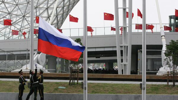 Hoisting the Russian flag during the opening ceremony of Russia Day at Shanghai World Expo.File photo - Sputnik International
