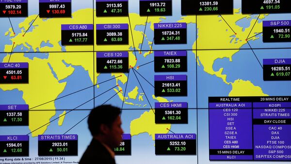 A man walks past a bank's electronic board showing the share index around the world at Hong Kong Stock Exchange Thursday, Aug. 27, 2015 - Sputnik International