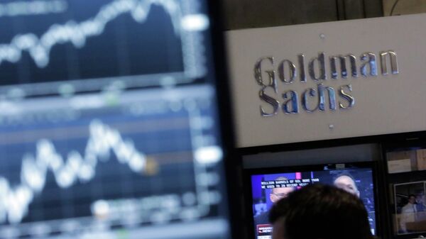 A screen at a trading post on the floor of the New York Stock Exchange is juxtaposed with the Goldman Sachs booth - Sputnik International