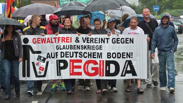 Participants of a rally called 'Patriotic Europeans against the Islamization of the West' (PEGIDA) demonstrate in Chemnitz, eastern Germany, Monday, Aug. 17, 2015 - Sputnik International