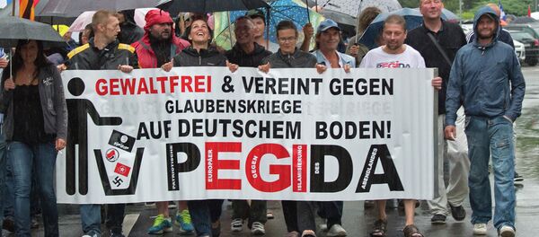 Participants of a rally called 'Patriotic Europeans against the Islamization of the West' (PEGIDA) demonstrate in Chemnitz, eastern Germany, Monday, Aug. 17, 2015 - Sputnik International