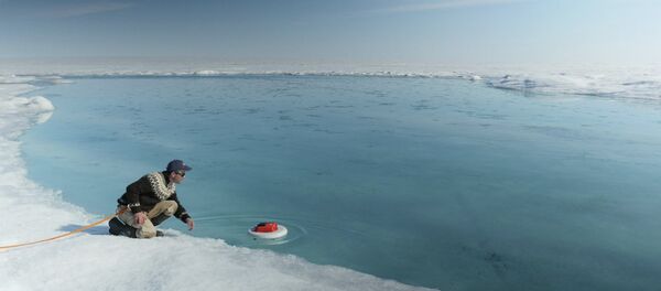 Laurence C. Smith, Chair of Geography at University of California, Los Angeles, deployed an autonomous drifter in a meltwater river on the surface of the Greenland ice sheet on July 19, 2015. Laurence C. Smith, Chair of Geography at University of California, Los Angeles, deployed an autonomous drifter in a meltwater river on the surface of the Greenland ice sheet on July 19, 2015. - Sputnik International