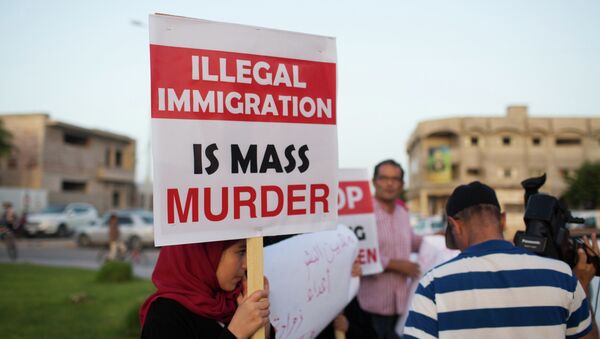 In this Thursday, Aug. 27, 2015 photo, local residents hold a demonstration against illegal immigration after hearing news that a boat carrying hundreds of migrants capsized off the coast, in Zuwara, Libya - Sputnik International