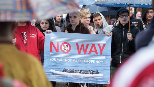 People take part at a demonstration initiated by right-wing NPD (National Democratic Party of Germany) against the German asylum law and asylum seekers in Riesa, eastern Germany, Tuesday, Aug. 18, 2015 - Sputnik International