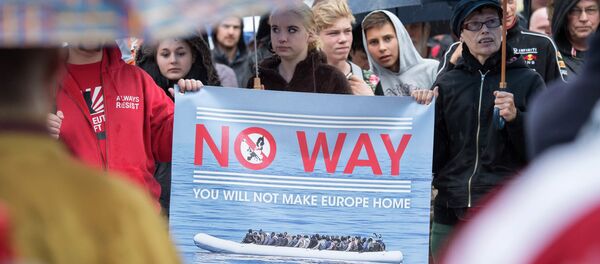 People take part at a demonstration initiated by right-wing NPD (National Democratic Party of Germany) against the German asylum law and asylum seekers in Riesa, eastern Germany, Tuesday, Aug. 18, 2015 - Sputnik International