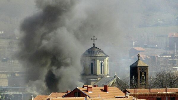 Smoke billows from Serbian Orthodox Church which was set ablaze by ethnic Albanian extremists in the northern Kosovo city of Kosovska Mitrovica, Thursday, March 18, 2004 - Sputnik International