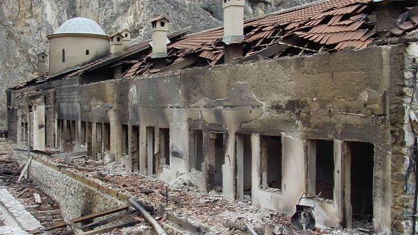 A general view shows the burned facade of the Serbian Orthodox monastery Sveti Arhandjeli in the southwestern Kosovar village of Prizren 23 March 2004 - Sputnik International