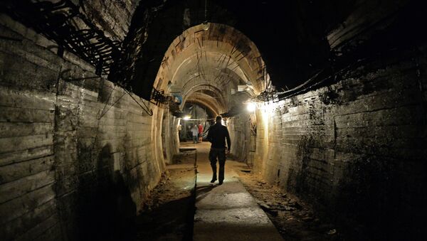 Men walk in underground galeries, part of Nazi Germany Riese construction project under the Ksiaz castle in the area where the Nazi gold train is supposedly hidden underground, on August 28, 2015 in Walbrzych, Poland. - Sputnik International
