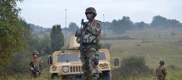 Moldovan soldiers of the Peacekeeping Battalion provide security during a Kosovo Force (KFOR) mission rehearsal exercise (MRE) at the Joint Multinational Readiness Center (JMRC) in Hohenfels, Germany, Oct. 1, 2014 Moldovan soldiers of the Peacekeeping Battalion provide security during a Kosovo Force (KFOR) mission rehearsal exercise (MRE) at the Joint Multinational Readiness Center (JMRC) in Hohenfels, Germany, Oct. 1, 2014 - Sputnik International